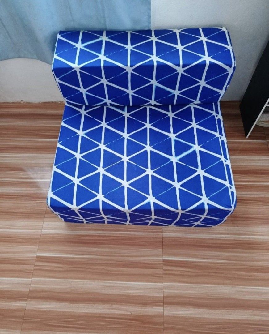 Amelie Sofa Bed 5.5x30x73 Blue Triangle Pattern (Category: Sofas) located in Mandaluyong City. Submitted by trisha_001 (Listing ID 1468976970, Image 1). Description: - Amelie Folding Sofa Bed (Blue with white triangle geometric pattern) - Dimensions: 5.5" x 30" x 73" - Versatile 2-in-1 design: Easily converts from a chair to a flat sleeping mat - Comfortable foam cushion core with a convenient removable printed cover - Ideal space saver for small