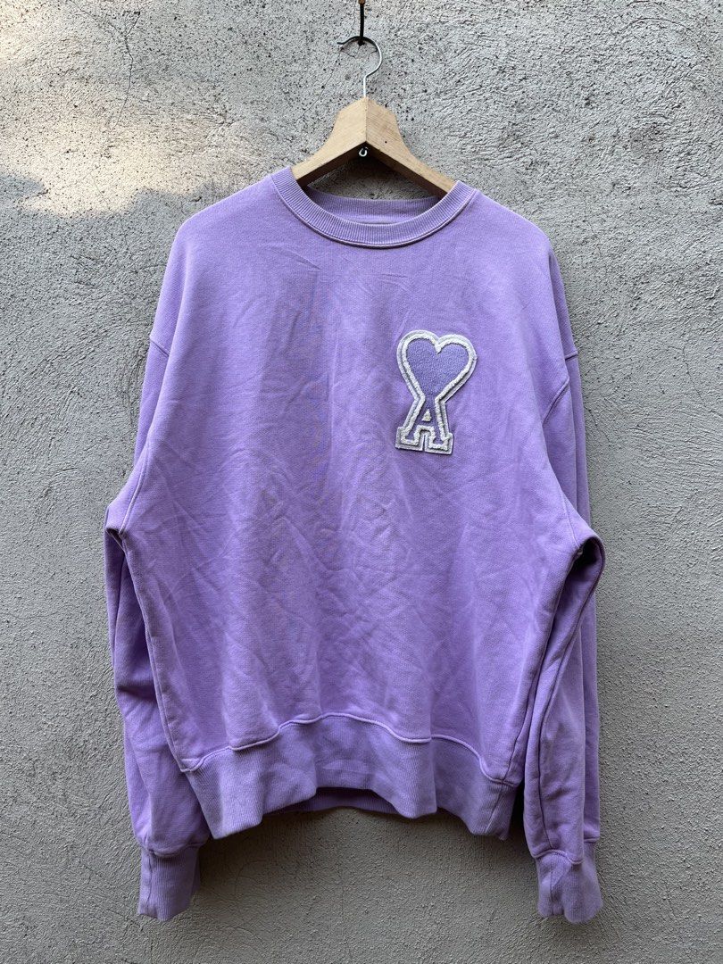 AMI Paris Purple Sweatshirt (Category: Coats, Jackets and Outerwear) located in Claveria. Submitted by jhonbernar74435 (Listing ID 1469088353, Image 1). Description: Purple sweatshirt from AMI Paris. Size medium. Iconic heart and letter logo patch embroidered on the chest. Embroidered lettering right below the back collar. Ribbed cuffs, hem, and crewneck. Organic cotton material. Soft fleece lining inside. Standard fit through the body. Clean fab