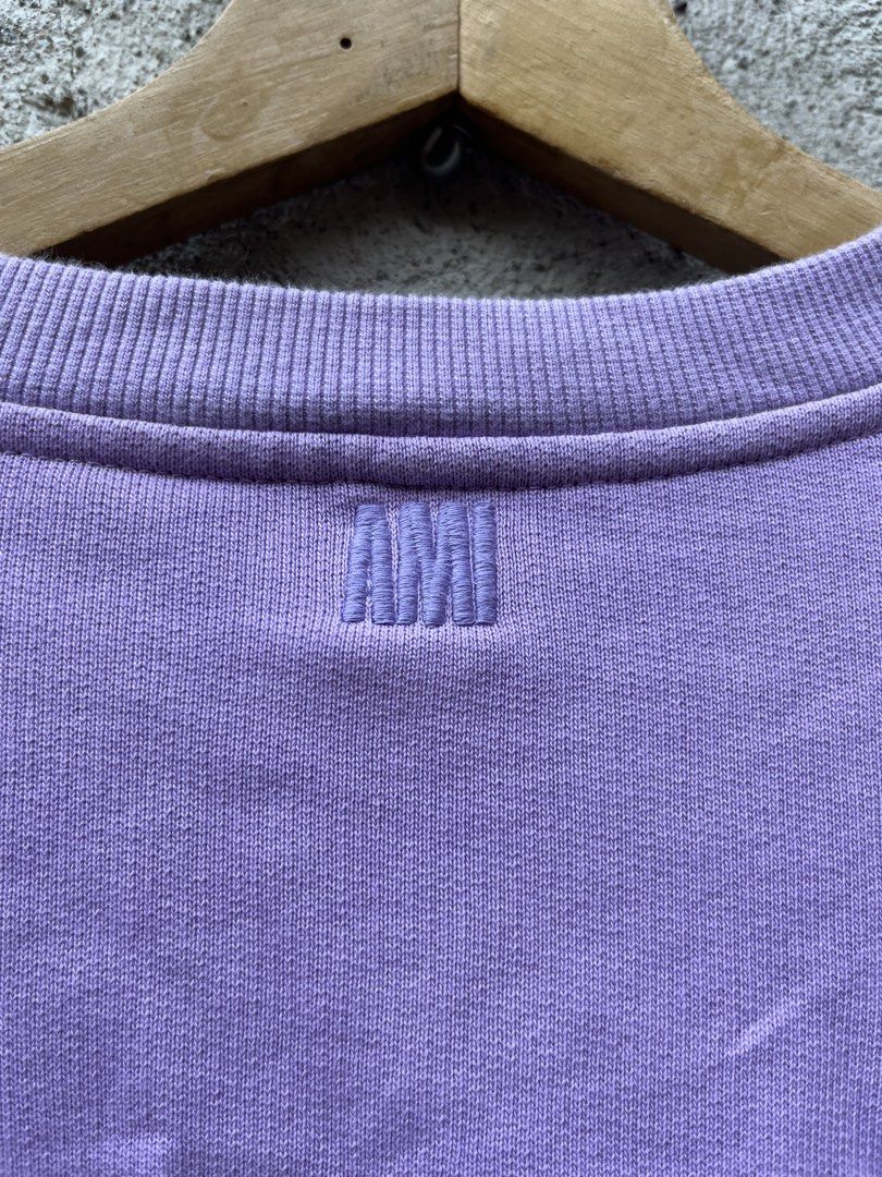 AMI Paris Purple Sweatshirt (Category: Coats, Jackets and Outerwear) located in Claveria. Submitted by jhonbernar74435 (Listing ID 1469088353, Image 2). Description: Purple sweatshirt from AMI Paris. Size medium. Iconic heart and letter logo patch embroidered on the chest. Embroidered lettering right below the back collar. Ribbed cuffs, hem, and crewneck. Organic cotton material. Soft fleece lining inside. Standard fit through the body. Clean fab