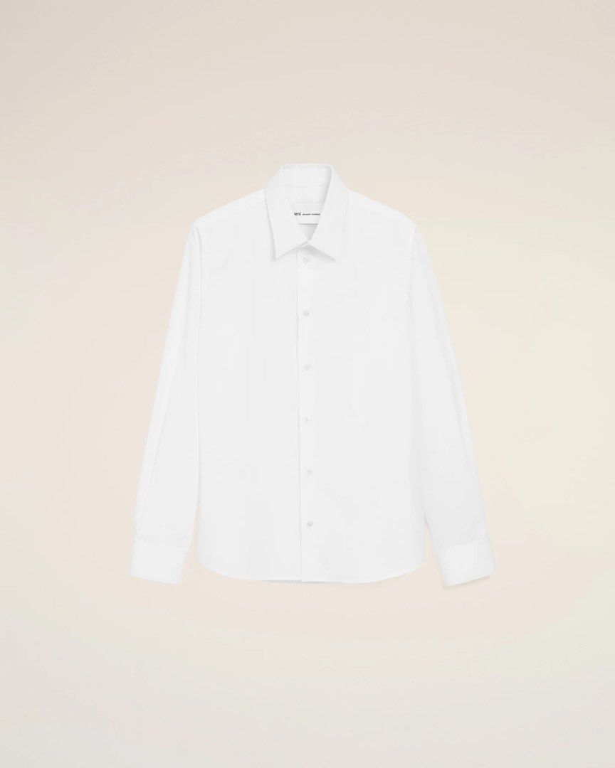Ami Paris White Long Sleeve Button-Up Shirt (Category: Formal Shirts) located in Manila. Submitted by theboyinthebubble (Listing ID 1469102593, Image 1). Description: AMI PARIS — WHITE COTTON AMI DE COEUR CLASSIC SHIRT Size: Small (S) Condition: Brand New With Tags (BNWT) * Never worn, never used * Original tags attached * Still in original plastic packaging * 100% authentic AMI Paris * Purchased in South Korea * White cotton poplin with tonal Am
