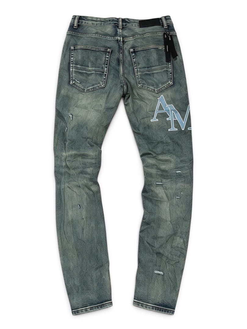 Amiri Distressed Denim Jeans Size 30 (Category: Jeans) located in Manila. Submitted by jerms.thriftah (Listing ID 1469043758, Image 2). Description: - Brand: Amiri - Style: Washed denim jeans with unique green-blue tint - Size: 30 (label inside) - Condition: Brand new with hang tag still attached at back waistband - Details: Distressed throughout the legs, large embroidered 'AM' lettering on the right back leg, and 'RI' patch on the front right.