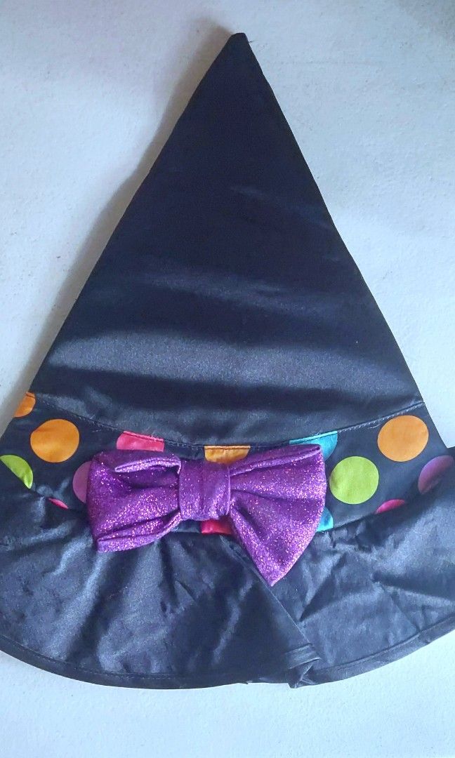 Amscan Miss Mapped Witch Hat for Kids (Category: Hats & Beanies) located in Baguio. Submitted by ayra1523 (Listing ID 1469013662, Image 1). Description: - Brand: Amscan - Material: Black satin with colourful polka dot band - Feature: Sparkling purple bow in front - Size: 4-6 years (height up to 110cm) - Care: Hand wash only - Perfect for Halloween and dress-up play.