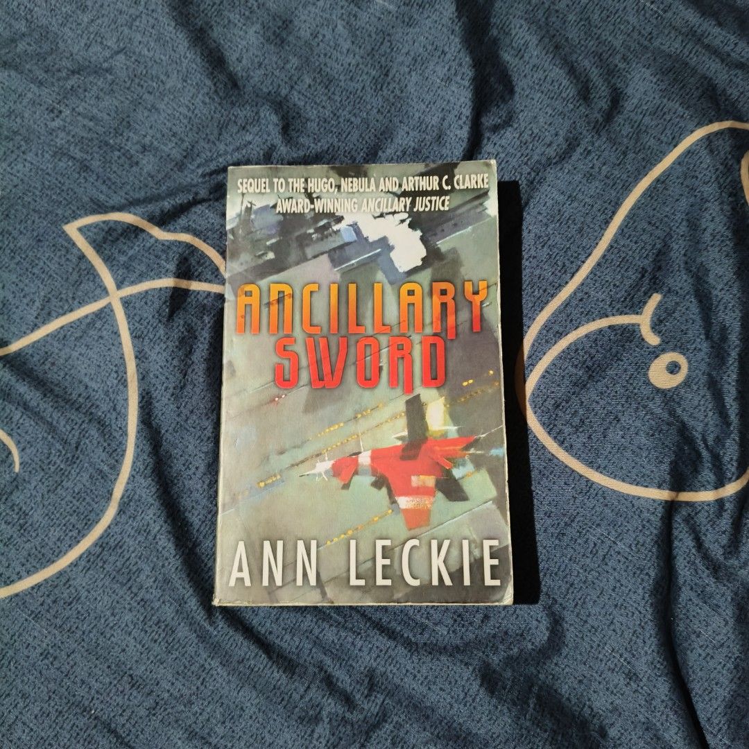Ancillary Sword by Ann Leckie (Category: Storybooks) located in Santo Domingo. Submitted by rajjinni (Listing ID 1469060411, Image 1). Description: - Title: Ancillary Sword by Ann Leckie (Book 2 of the Imperial Radch Trilogy) - Publisher: Orbit - Format: Paperback - Condition: Pages have age-related yellowing; cover has minor creasing and edge wear - Note: Sequel to the multi-award-winning Ancillary Justice - Perfect for science fiction collector
