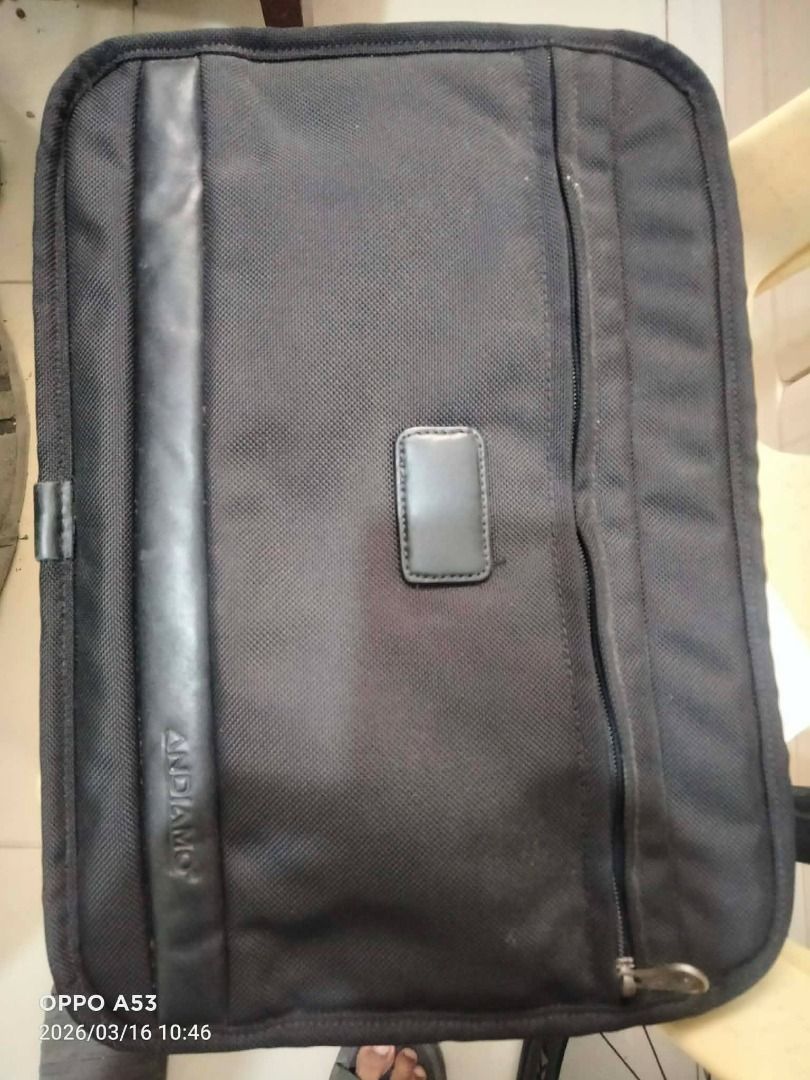 Andiamo Black Laptop Bag Briefcase (Category: Laptop Bags & Sleeves) located in Binan City. Submitted by rpute (Listing ID 1468955141, Image 1). Description: - Brand: Andiamo - Color: Classic Black - Material: Durable textured fabric with smooth faux leather panel - Pockets: Convenient vertical zippered pocket on the right side - Branding: Embossed logo text and small rectangular center patch - Condition: Lightly used / Excellent quality.