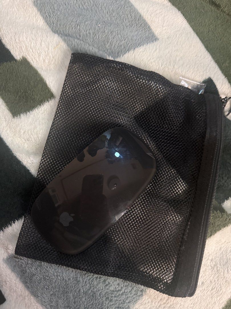 Apple Magic Mouse Black (Category: Mouse & Mousepads) located in Valenzuela. Submitted by baby00000 (Listing ID 1469067071, Image 1). Description: - Authentic Apple wireless mouse in a sleek black finish - Features the classic Apple logo near the bottom - 100% working condition and compatible with Mac computers - Clean overall appearance, well-maintained - Includes a convenient black mesh pouch for storage and travel - Meet-ups or shipping option