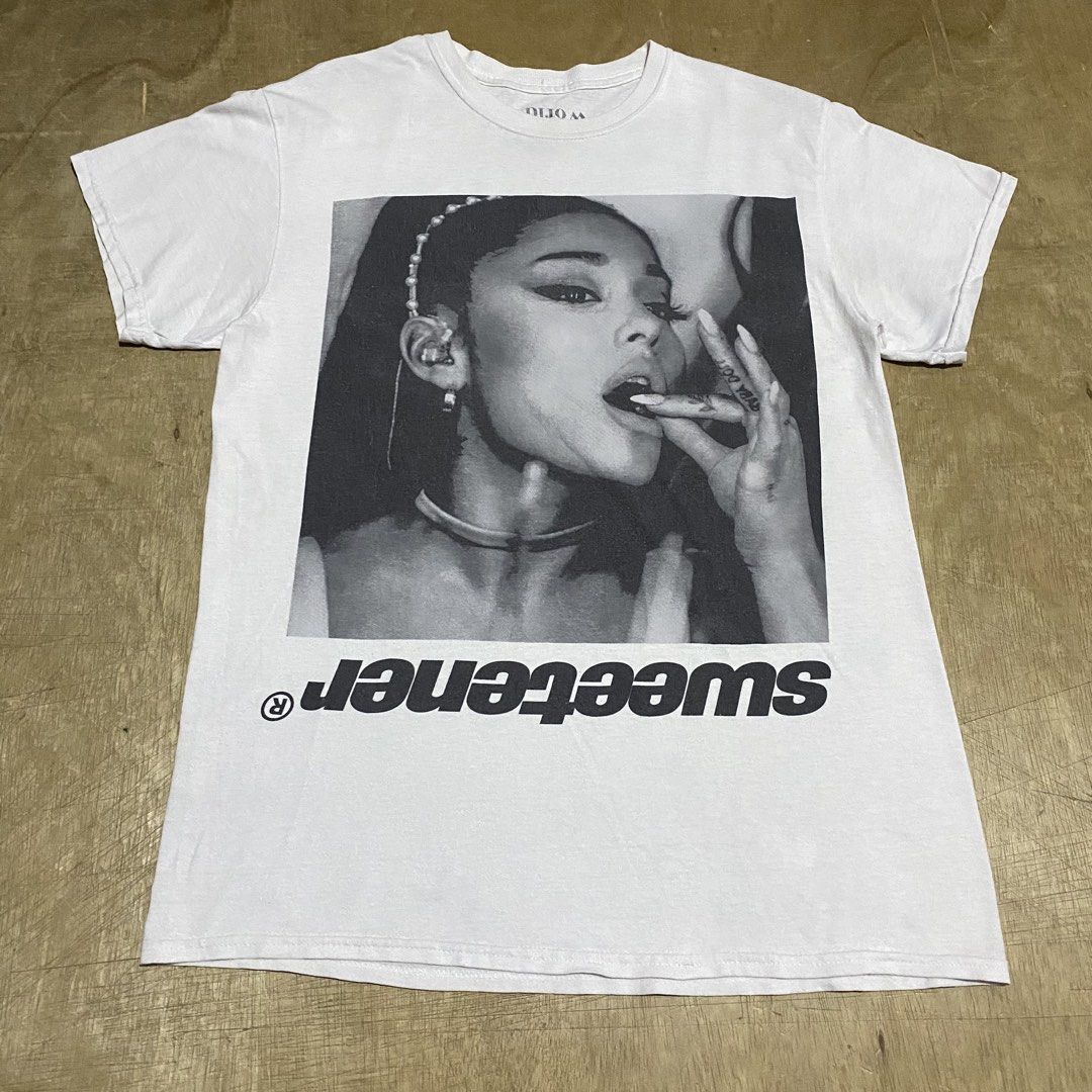 ARIANA GRANDE (Category: Shirts) located in Makati City. Submitted by kktrippy (Listing ID 1469007981, Image 1). Description: - SWEETENER world tour - Cool ariana portrait with tour - Good condition - Medium - official printed tag - Measurement/dimension is on the tape 2nd slide.