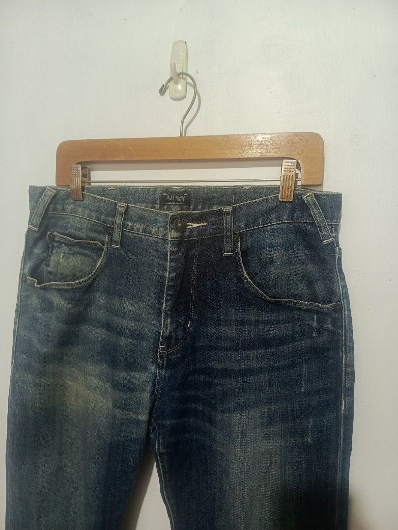 ARMANI JEANS PANTS (Category: Jeans) located in Baguio. Submitted by 074thriftmania (Listing ID 1468967965, Image 2). Description: - Brand: Armani Jeans - Wash: Dark wash with vintage fading and whiskering - Fit: Straight leg cut, classic five-pocket styling - Details: Branded metal button closure, inner waistband label, and rear leather patch - Accent: Signature metal eagle logo plaque on the back pocket - Material: Sturdy, structured premium de