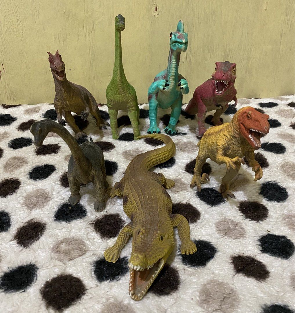 Assorted dinosaur and crocodile toy figures lot (Category: Action & Battle Toys) located in Baguio. Submitted by thrift_bonita (Listing ID 1469030334, Image 1). Description: - Total of 7 vibrant plastic toys - Includes T-Rex, long-necks, and a large open-mouth crocodile - Features bright colors like green, red, teal, and yellow - Great for kids' playtime, imaginative adventures, or room display - Ready for shipping or meetup in the Philippines!.
