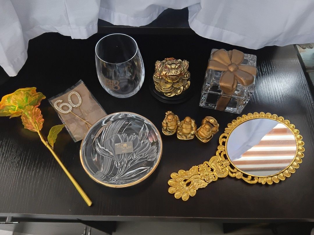 Assorted Home Decor Items Glassware Figurines and Mirror Bundle (Category: Everything Else Others) located in Manila. Submitted by madewdjoy (Listing ID 1468995523, Image 2). Description: - Bundle of home decor and decorative items from storage - Studio Nova glass dish and wine glass - Crystal gift box container - Gold peacock hand mirror - Three laughing Buddha figures and a money toad figurine - Gold foil rose and 60th birthday cake toppers - S