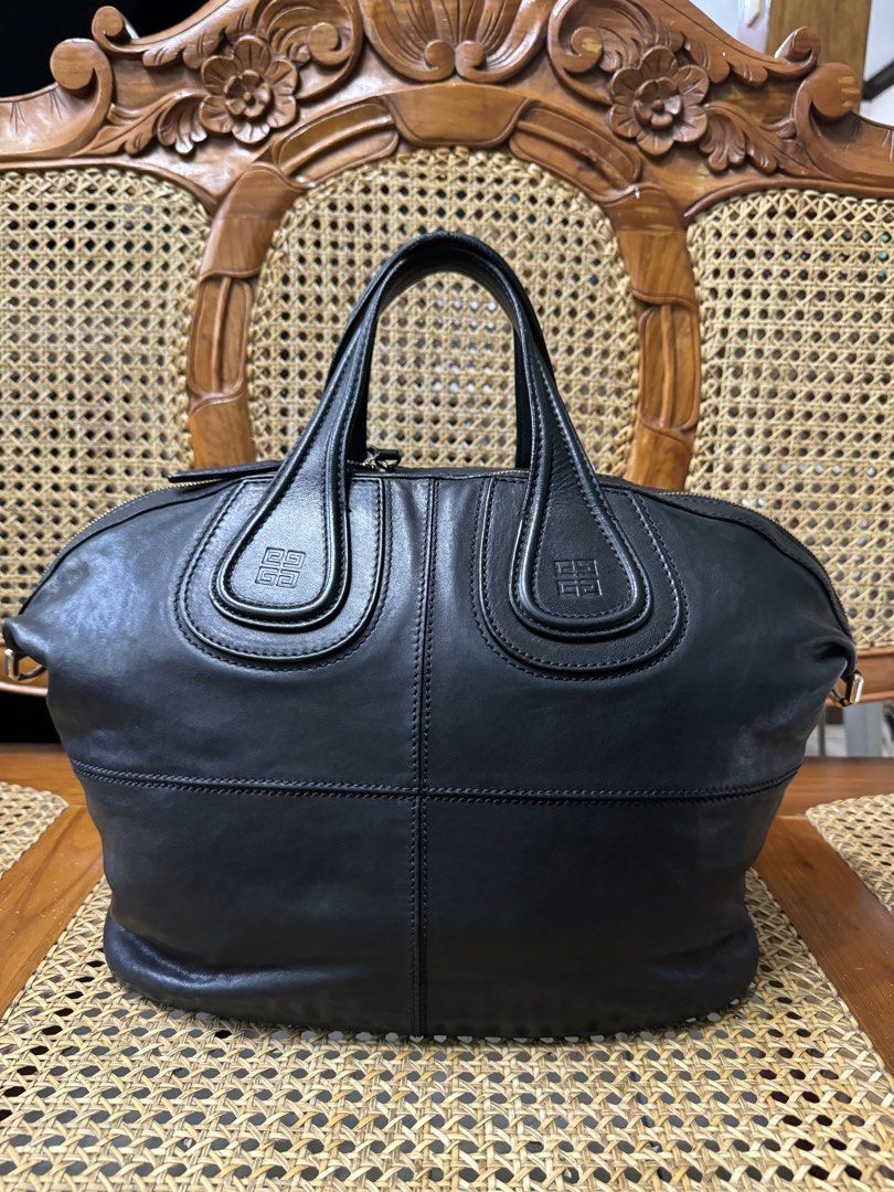 [AUTHENTIC] Givenchy Black Leather Handbag (Category: Luxury Bags & Wallets) located in Santa Rosa. Submitted by rjaarmblo (Listing ID 1469030570, Image 3). Description: - Brand: Givenchy - Material: Premium black leather - Style: Structured handbag with top handles and vertical stitching - Closure: Secure zip top - Interior Features: Dark fabric lining, zipper pocket, brand label tag, and serial number tag (MA 0162) - Inclusion: Free 'Love My Ba