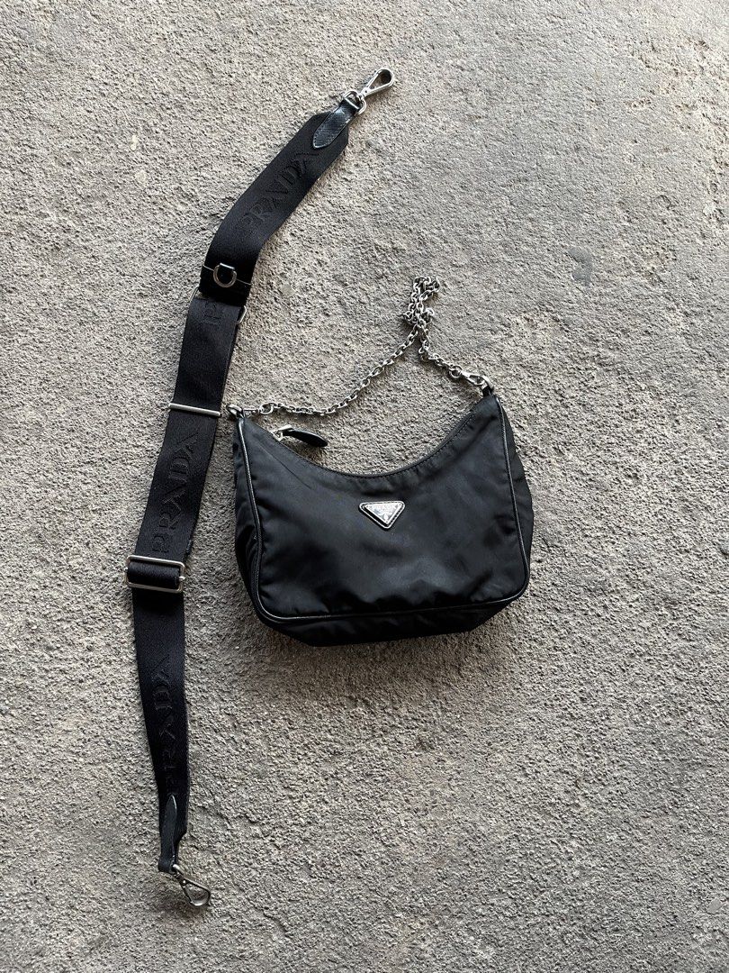 Authentic Prada Re-Edition Black Nylon Shoulder Bag (Category: Luxury Bags & Wallets) located in General Santos City (Dadiangas). Submitted by thiftnibadi3 (Listing ID 1469045616, Image 1). Description: - Authentic Prada shoulder bag in classic black nylon - Silver-tone hardware with stylish metal chain handle - Includes adjustable jacquard logo strap for versatile wear - Practical crescent shape that easily fits daily essentials - Interior featu