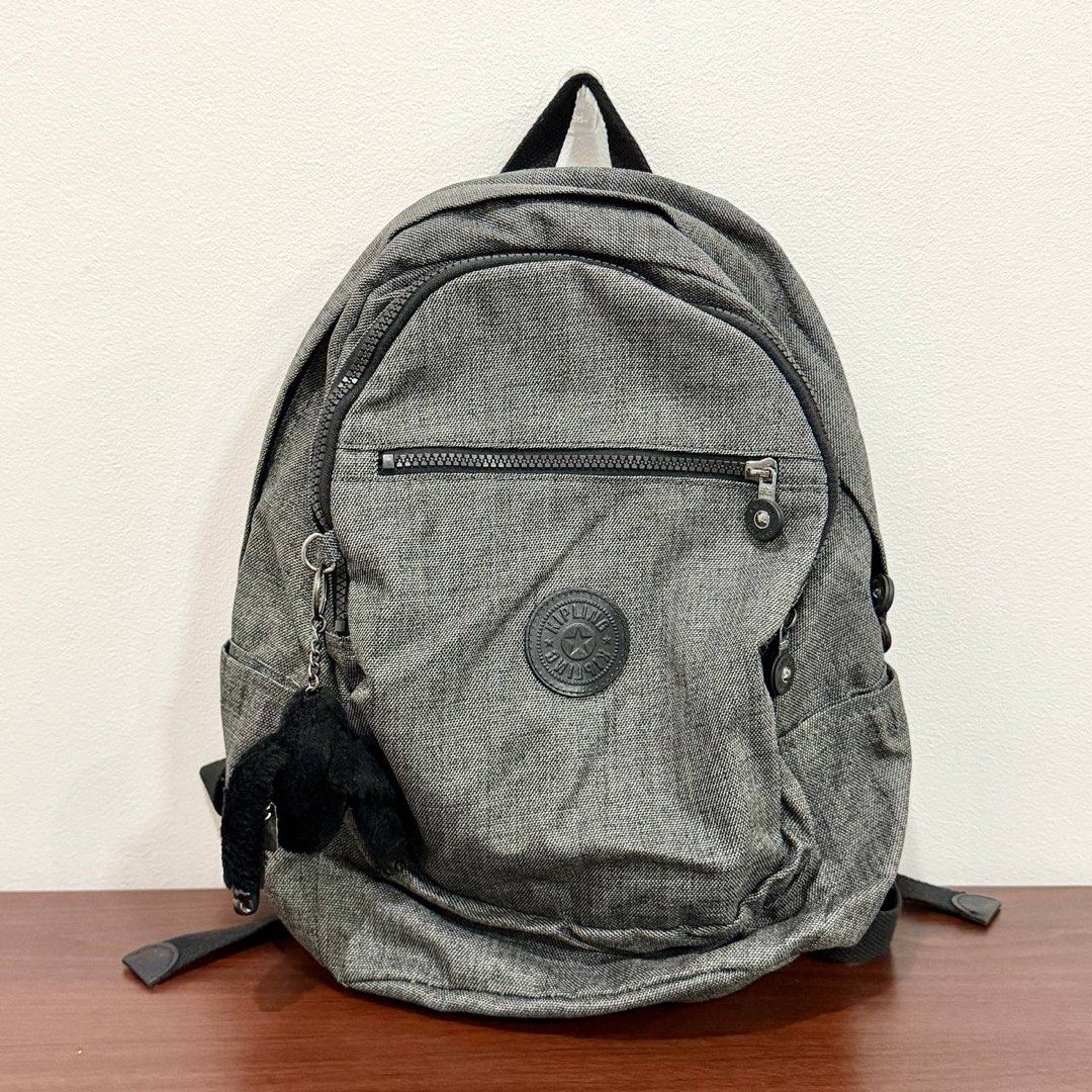[Authentic] Used Kipling Backpack Gray Black Monkey Keychain Zip Pockets Checkered Lining (Category: Backpacks) located in Quezon City. Submitted by brandedusagoodies (Listing ID 1469117868, Image 1). Description: Used Kipling backpack in gray with the Kipling logo patch, a front zip pocket, side pockets, a top handle and adjustable padded straps. Comes with a black Kipling monkey keychain. The inside has a checkered Kipling lining with a zip poc