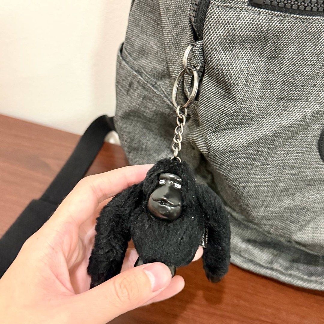[Authentic] Used Kipling Backpack Gray Black Monkey Keychain Zip Pockets Checkered Lining (Category: Backpacks) located in Quezon City. Submitted by brandedusagoodies (Listing ID 1469117868, Image 3). Description: Used Kipling backpack in gray with the Kipling logo patch, a front zip pocket, side pockets, a top handle and adjustable padded straps. Comes with a black Kipling monkey keychain. The inside has a checkered Kipling lining with a zip poc