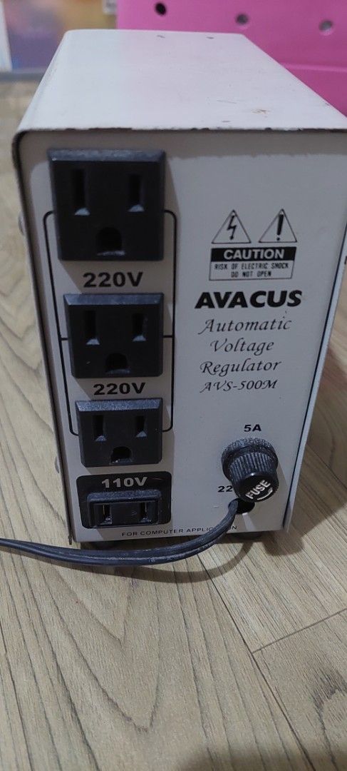 Avacus Automatic Voltage Regulator AVS-500M (Category: Electrical, Adaptors & Sockets) located in Taguig. Submitted by thrifthub.ph (Listing ID 1469077131, Image 1). Description: - Model: Avacus AVS-500M Automatic Voltage Regulator (AVR) - Output: Multiple 220V and 110V sockets on the back panel - Protection: Built-in 5A fuse cap for safety - Front Panel: Analog needle voltage meter, power switch, and indicator light - Condition: White metal casi