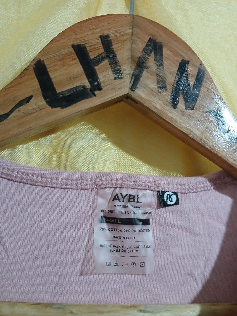 AYBL Pink Crop Top Size S (Category: Sleeveless) located in Taguig. Submitted by thriftnilhan (Listing ID 1468947478, Image 3). Description: - Brand: AYBL - Item: Cropped Workout Top - Color: Pale Pink with white front logo - Size: Small (Tag attached) - Fit & Style: Short, boxy fit with raw hem details on neckline and sleeves - Material: 79% Cotton, 21% Polyester (Machine washable) - Condition: Brand new with tags - Ideal for: Gym sessions and c