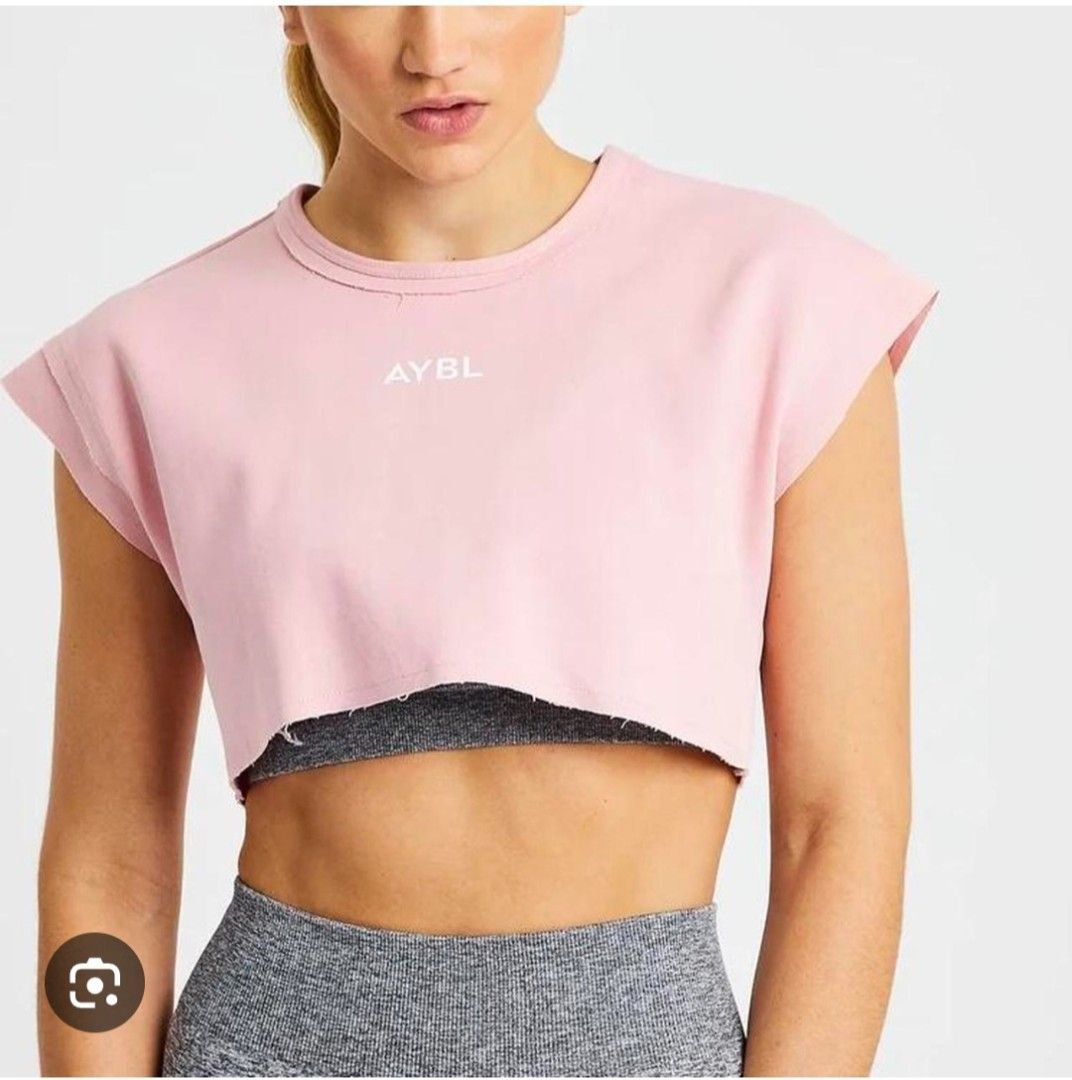 AYBL Pink Crop Top Size S (Category: Sleeveless) located in Taguig. Submitted by thriftnilhan (Listing ID 1468947478, Image 2). Description: - Brand: AYBL - Item: Cropped Workout Top - Color: Pale Pink with white front logo - Size: Small (Tag attached) - Fit & Style: Short, boxy fit with raw hem details on neckline and sleeves - Material: 79% Cotton, 21% Polyester (Machine washable) - Condition: Brand new with tags - Ideal for: Gym sessions and c