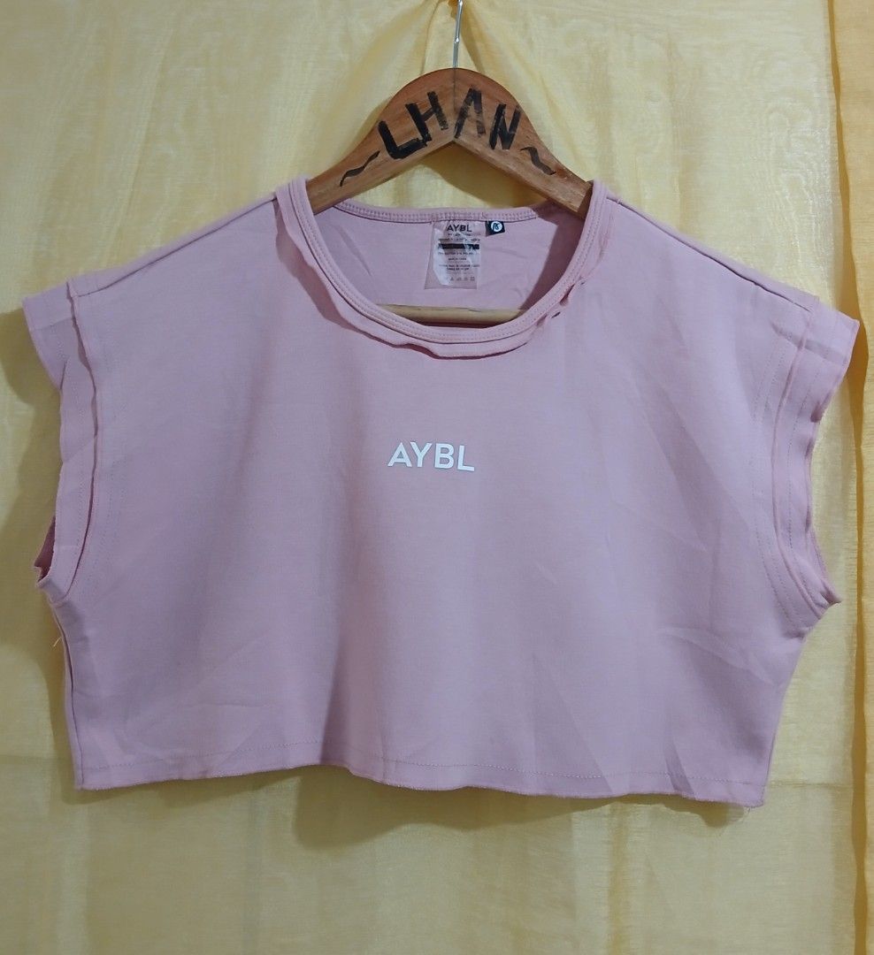 AYBL Pink Crop Top Size S (Category: Sleeveless) located in Taguig. Submitted by thriftnilhan (Listing ID 1468947478, Image 1). Description: - Brand: AYBL - Item: Cropped Workout Top - Color: Pale Pink with white front logo - Size: Small (Tag attached) - Fit & Style: Short, boxy fit with raw hem details on neckline and sleeves - Material: 79% Cotton, 21% Polyester (Machine washable) - Condition: Brand new with tags - Ideal for: Gym sessions and c