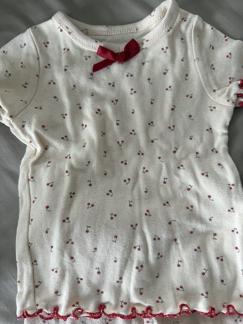 Baby Cherry Print Pyjamas Set Size 80 (Category: Babies & Kids Fashion) located in Manila. Submitted by 17thfinds (Listing ID 1468965148, Image 3). Description: - Size: 80 (Tag attached) - Material: 100% pure cotton for maximum comfort - Design: Cream-coloured with all-over sweet cherry print - Set includes: 1 short-sleeve top and 1 long pants - Cute details: Small red ribbon at the neckline and trendy red lettuce edge trimming on cuffs, hems, an