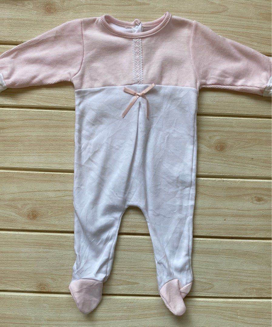 baby sleepsuit 3-6m (Category: Babies & Kids Fashion) located in Cebu City. Submitted by yjainani (Listing ID 1469010988, Image 1). Description: pink and white long-sleeved closed-foot baby sleepsuit featuring a ribbed top, a decorative lace trim, and a small bow accent at the chest..