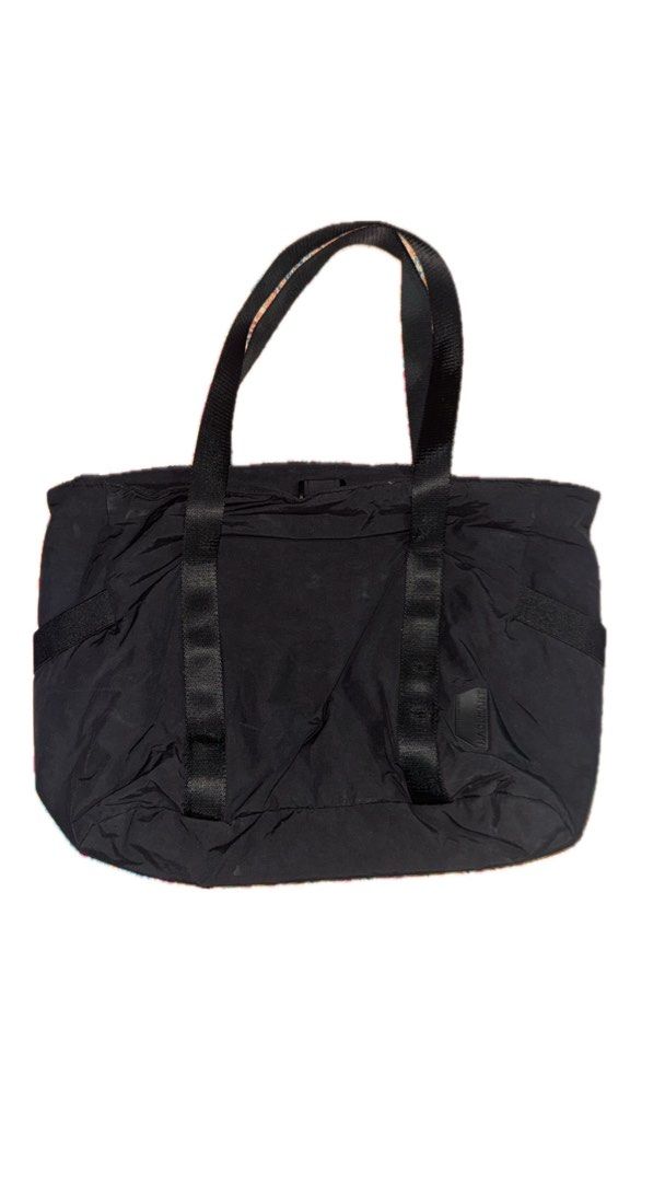 BAGSMART Black Tote Bag (Category: Tote Bags) located in Malabon City. Submitted by imjustagirl_ (Listing ID 1469043578, Image 2). Description: - Brand: BAGSMART - Color: Classic Black - Material: Durable nylon - Straps: Sturdy and comfortable for daily wear - Organization: Multiple exterior pockets on the sides and back - Details: Features BAGSMART logo patch near the bottom right - Condition: Clean interior and exterior, well-maintained.
