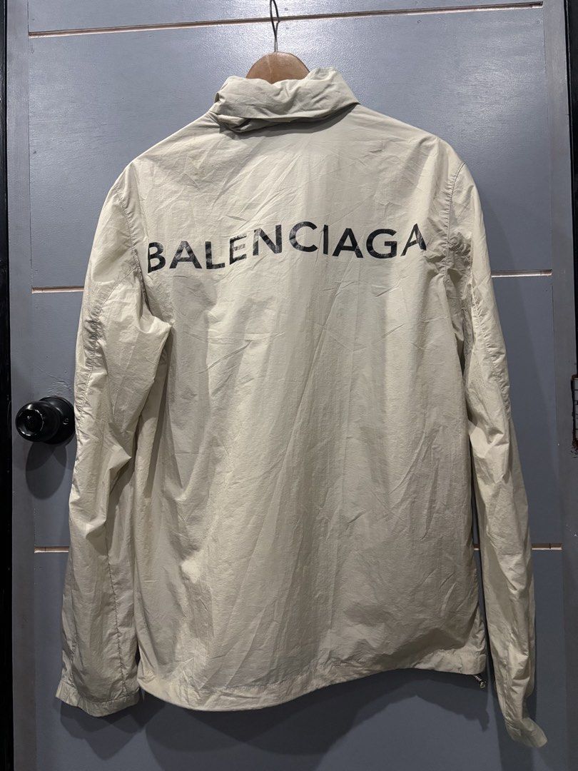 Balenciaga Nylon Windbreaker Jacket Off White (Category: Coats, Jackets and Outerwear) located in Manila. Submitted by happywind_ba7b96 (Listing ID 1468997179, Image 2). Description: - Brand: Balenciaga - Style: Lightweight nylon windbreaker jacket - Color: Off-white with bold black back logo and small embroidered chest logo - Features: Full zip closure, stand collar, and convenient front pockets - Condition: Excellent / Pre-loved (ready to wear)