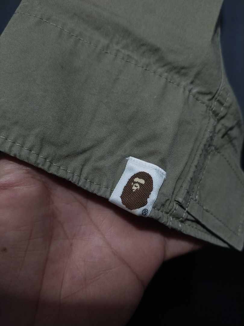 Bape Maritime Squadron Military Cargo Pants (Category: Jeans) located in Pasig City. Submitted by loveforlux_2025 (Listing ID 1468940588, Image 2). Description: - Authentic BAPE cargo pants in a stylish olive green color - Relaxed fit utility style for maximum comfort - Multiple practical utility pockets and reinforced knee panels - Adjustable velcro cuffs at the ankles for a customizable fit - Branded buttons and signature ape head tag near the 