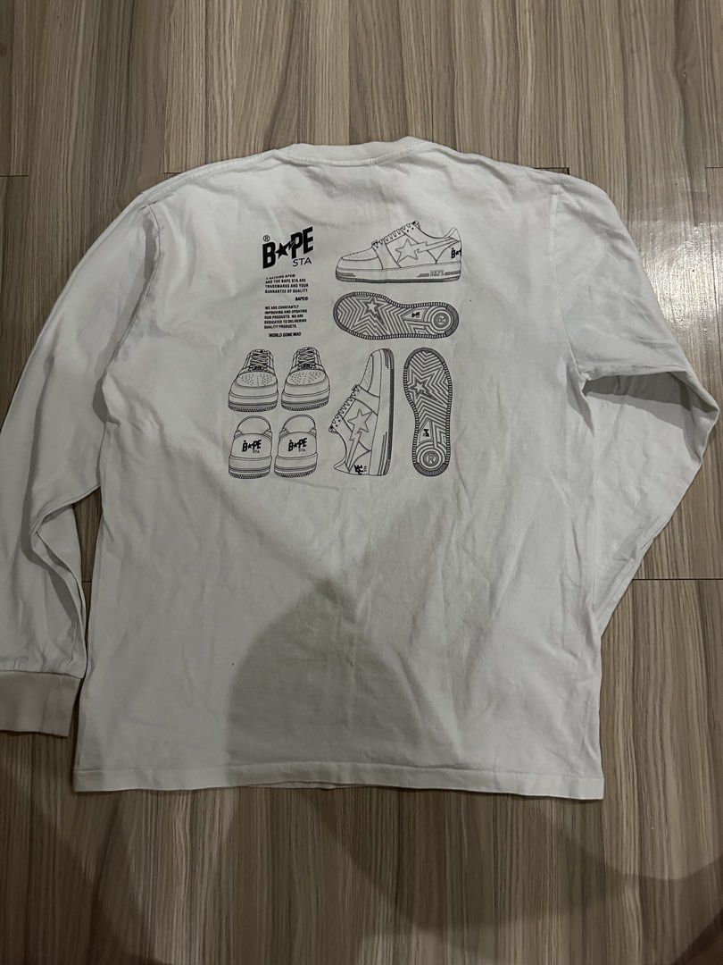 BAPE STA White Long Sleeve Tee (Category: Tshirts & Polo Shirts ) located in Quezon City. Submitted by stre3tw3ar (Listing ID 1468936359, Image 3). Description: - Brand: BAPE - Color: Clean White - Style: Long sleeve, round collar, standard fit - Details: Classic BAPE STA chest print and bold sneaker back graphics - Authenticity markers: Woven size label and gold ape tag on inside collar - Condition: Excellent.