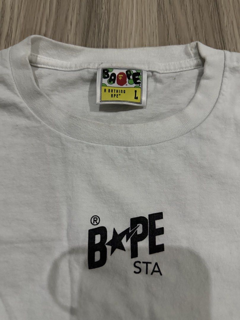 BAPE STA White Long Sleeve Tee (Category: Tshirts & Polo Shirts ) located in Quezon City. Submitted by stre3tw3ar (Listing ID 1468936359, Image 2). Description: - Brand: BAPE - Color: Clean White - Style: Long sleeve, round collar, standard fit - Details: Classic BAPE STA chest print and bold sneaker back graphics - Authenticity markers: Woven size label and gold ape tag on inside collar - Condition: Excellent.