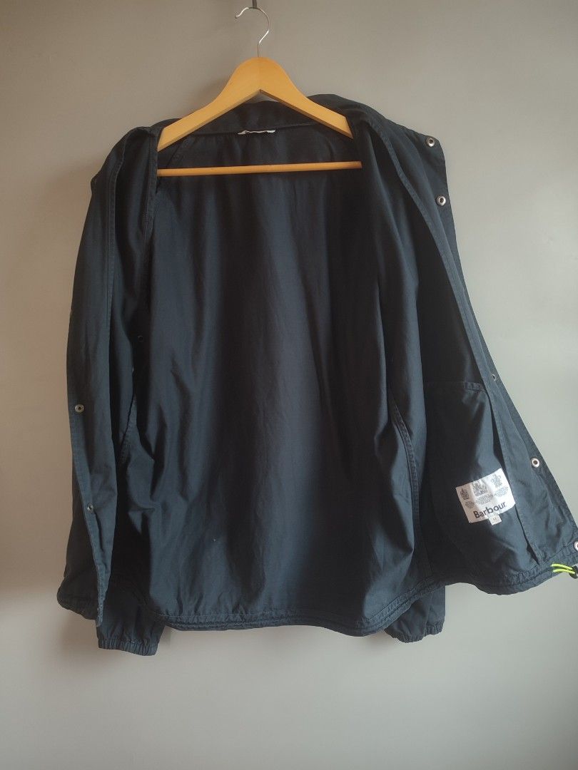 Barbour jacket (Category: Coats, Jackets and Outerwear) located in Lipa City. Submitted by gudoys_outdoor16 (Listing ID 1469043382, Image 3). Description: - Brand: Barbour Beacon - Style: Coach jacket - Color: Navy blue - Size: Medium (M) - Features: Snap button closure, two hand pockets, elastic cuffs, and drawstring hem - Logo: Iconic Barbour Beacon lighthouse patch on the chest - Condition: Clean inside and out, excellent pre-loved condition -