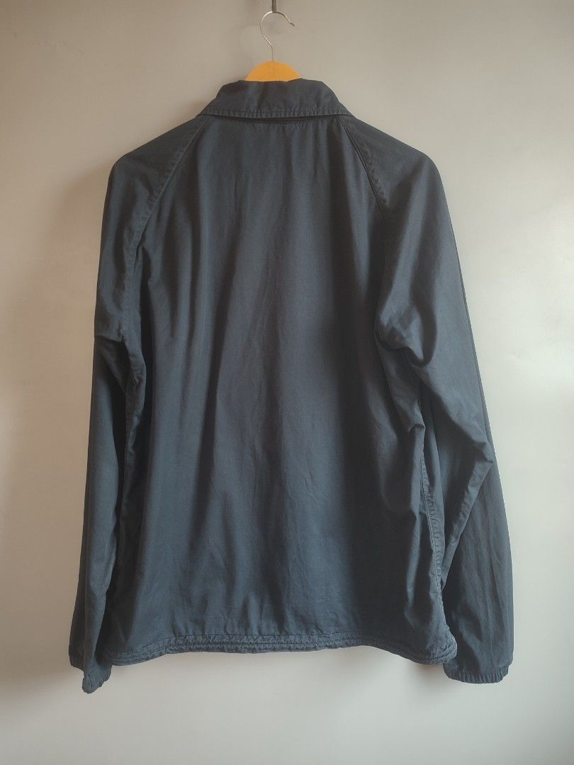 Barbour jacket (Category: Coats, Jackets and Outerwear) located in Lipa City. Submitted by gudoys_outdoor16 (Listing ID 1469043382, Image 2). Description: - Brand: Barbour Beacon - Style: Coach jacket - Color: Navy blue - Size: Medium (M) - Features: Snap button closure, two hand pockets, elastic cuffs, and drawstring hem - Logo: Iconic Barbour Beacon lighthouse patch on the chest - Condition: Clean inside and out, excellent pre-loved condition -