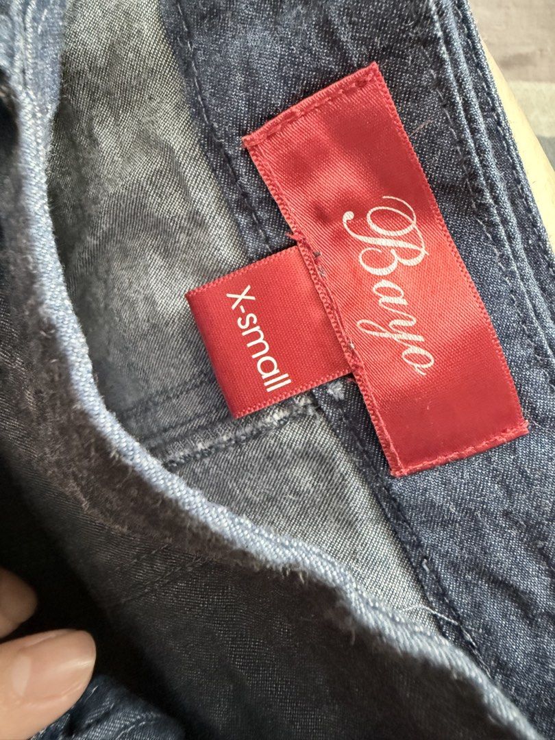 Bayo Denim Skirt (Category: Skirts) located in Paranaque City. Submitted by roanclauds (Listing ID 1468955905, Image 3). Description: - Brand: Bayo - Style: Denim skirt with straight cut design - Color/Wash: Medium blue wash - Size: X-Small (XS) fits 25 in - Details: Front tie sash at the waistband, two front pockets, back zipper closure - Condition: Excellent casual piece for everyday styling.