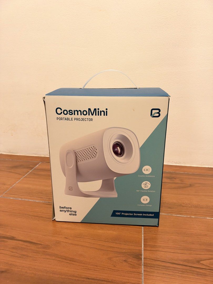 Before Anything Else CosmoMini Portable Projector (Category: Projectors) located in Manila. Submitted by brightstone_0013f2 (Listing ID 1469082455, Image 1). Description: - Model: CosmoMini Portable Projector (White) - Condition: Brand new, sealed in box - Design: Compact with 180-degree flexible rotation - Features: Cosmic ambience lighting & smart screen mirroring - Included Freebies: 1m HDMI cable, 100-inch projector screen, and carrying bag -