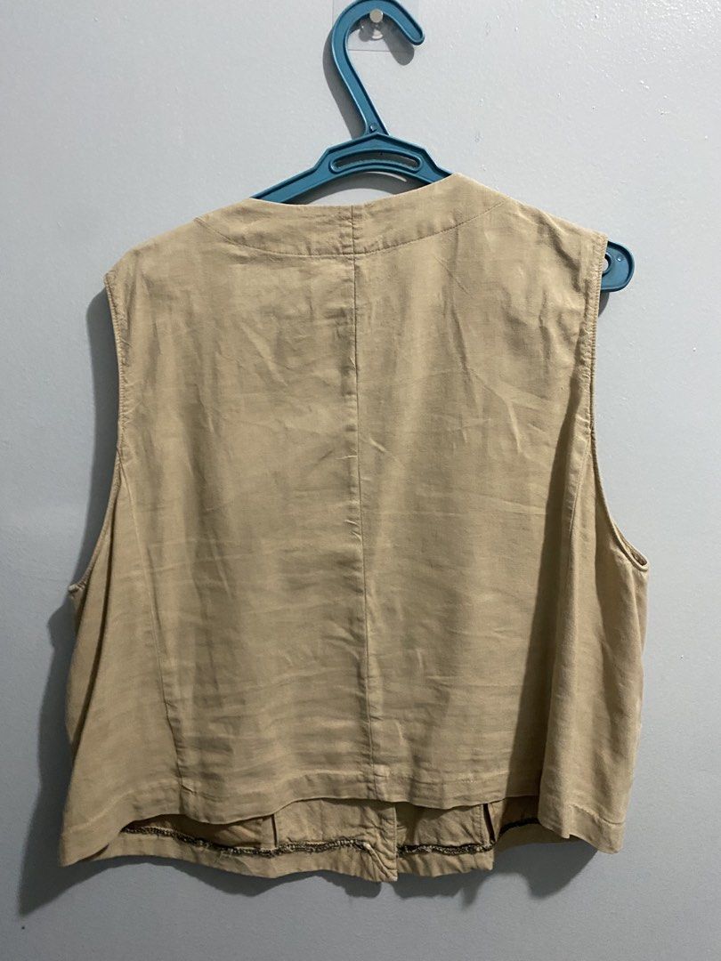 Beige Button-Up Sleeveless Vest - GU (Category: Sleeveless) located in Mandaluyong City. Submitted by _adjh (Listing ID 1469143476, Image 2). Description: - Color: Neutral beige - Design: V-neckline with a structured, sleeveless fit - Details: Four matching front buttons and two lower welt pockets - Styling: Perfect layering piece for casual outfits, easily matches basic tees and blouses.