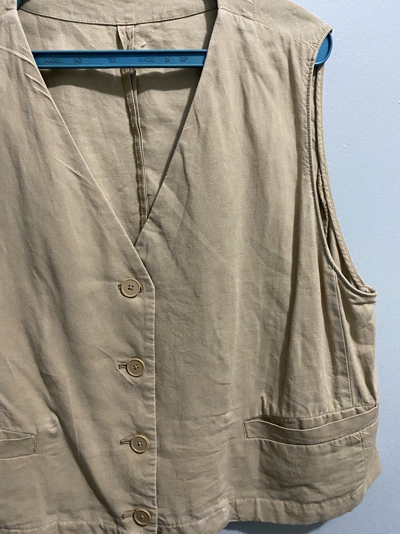 Beige Button-Up Sleeveless Vest - GU (Category: Sleeveless) located in Mandaluyong City. Submitted by _adjh (Listing ID 1469143476, Image 3). Description: - Color: Neutral beige - Design: V-neckline with a structured, sleeveless fit - Details: Four matching front buttons and two lower welt pockets - Styling: Perfect layering piece for casual outfits, easily matches basic tees and blouses.