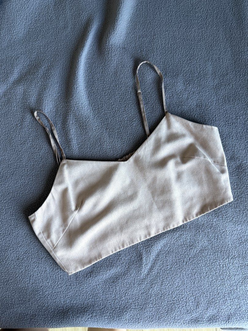 Beige cropped cami top with smocked back and side zip (Category: Sleeveless) located in Pasig City. Submitted by laagn.ph (Listing ID 1469086473, Image 1). Description: - Color: Neutral beige / taupe - Style: Cropped cami top with adjustable spaghetti straps - Fit: Smooth front with a fully smocked elastic back panel for extra stretch and a snug fit - Closure: Side zipper for easy wear - Versatility: Perfect for pairing with high-waisted jeans, s