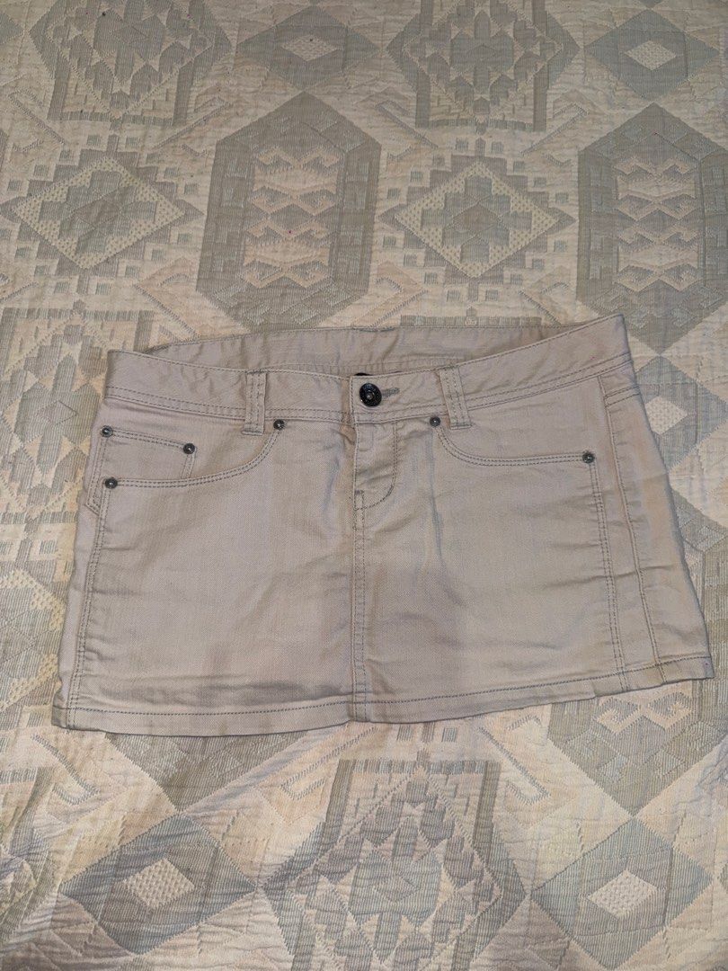 Beige Denim Skirt Size 8 (Category: Skirts) located in Manila. Submitted by andreaaarut2 (Listing ID 1469018359, Image 1). Description: RFS: Big on the waist for me :) Item is still in super great quality - Brand/Style: NET Ladies denim skirt - Color: Neutral beige - Size: 8 - Design: Classic five-pocket style with contrast stitching and belt loops - Details: Front button closure, back pockets with stitched V-design and metal rivets - Condition: 