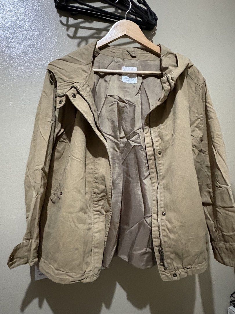 Beige Hooded Utility Jacket with Front Pockets (Category: Coats, Jackets and Outerwear) located in Caloocan City. Submitted by stella_mari27 (Listing ID 1469091673, Image 2). Description: - Color: Neutral beige - Style: Casual hooded utility jacket - Closure: Full zipper with front snap buttons - Pockets: Two angled front pockets with snap closures - Fit/Adjustability: Drawstring hem and adjustable snap cuffs - Interior: Fully lined with standard