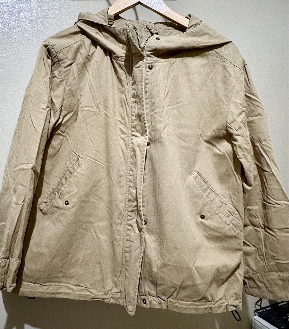 Beige Hooded Utility Jacket with Front Pockets (Category: Coats, Jackets and Outerwear) located in Caloocan City. Submitted by stella_mari27 (Listing ID 1469091673, Image 1). Description: - Color: Neutral beige - Style: Casual hooded utility jacket - Closure: Full zipper with front snap buttons - Pockets: Two angled front pockets with snap closures - Fit/Adjustability: Drawstring hem and adjustable snap cuffs - Interior: Fully lined with standard