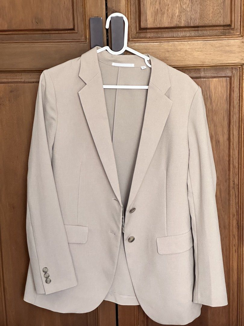 Beige tailored blazer jacket (Category: Coats, Jackets and Outerwear) located in Taguig. Submitted by melsofficewear (Listing ID 1468976304, Image 2). Description: - Color: Neutral beige - Style: Tailored blazer with structured shoulders - Details: Classic notched lapel, two front button closure, flap waist pockets, and decorative sleeve buttons - Interior: Fully lined - Fabric: Lightweight and ideal for layering - Versatility: A timeless wardrob