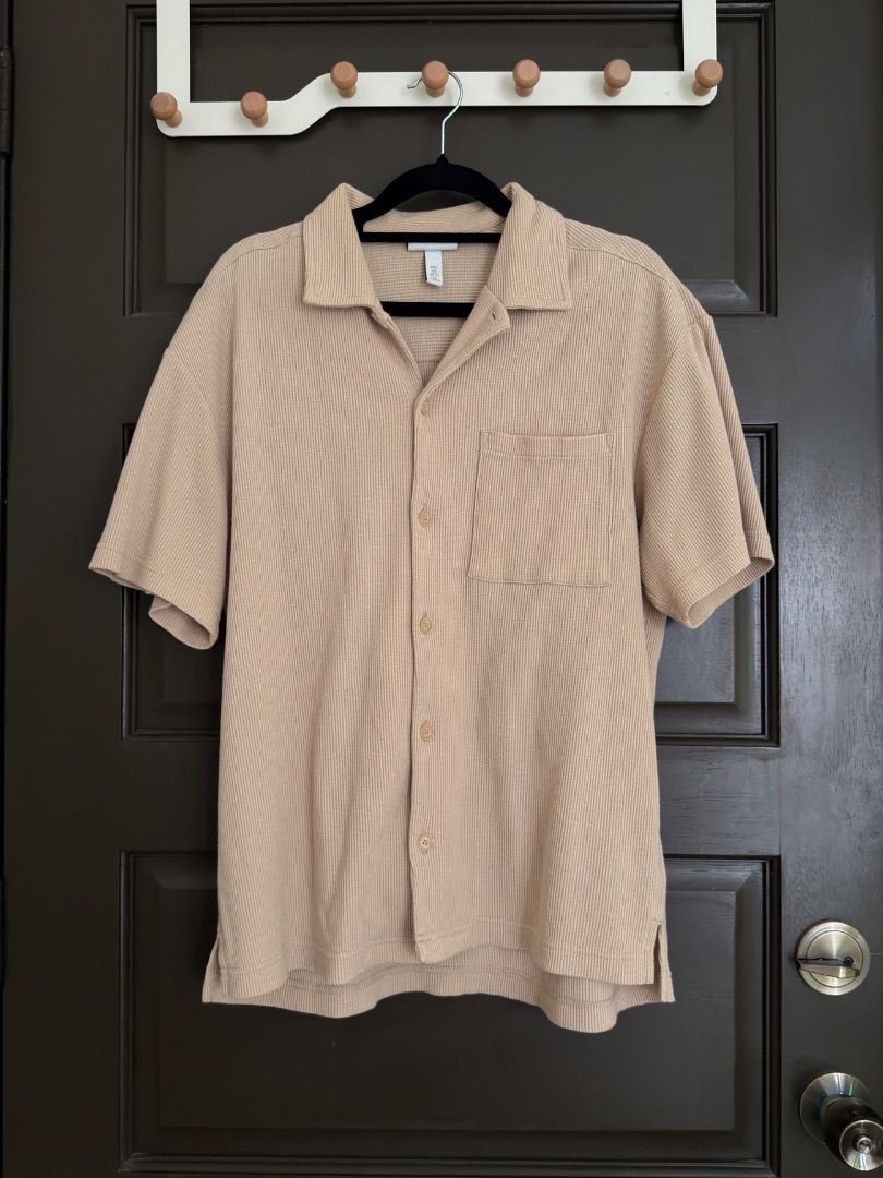 Beige Textured Short Sleeve Button Down Shirt (Category: Tshirts & Polo Shirts ) located in Calamba. Submitted by prongsiepoo (Listing ID 1469080421, Image 1). Description: - Color: Versatile beige - Material: Textured waffle fabric - Design: Camp collar, front button closure, and single chest pocket - Fit: Relaxed fit for daily comfort - Condition: Clean and ready to wear.