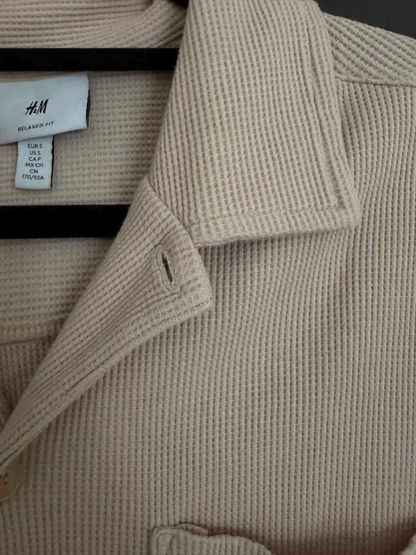 Beige Textured Short Sleeve Button Down Shirt (Category: Tshirts & Polo Shirts ) located in Calamba. Submitted by prongsiepoo (Listing ID 1469080421, Image 3). Description: - Color: Versatile beige - Material: Textured waffle fabric - Design: Camp collar, front button closure, and single chest pocket - Fit: Relaxed fit for daily comfort - Condition: Clean and ready to wear.