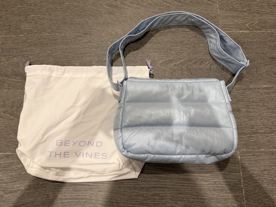 Beyond The Vines Puffer Metallic Bag Light Blue (Category: Cross-body Bags) located in Manila. Submitted by pinkyclothes1267 (Listing ID 1469034635, Image 2). Description: - Brand: Beyond The Vines - Style: Puffer Messenger Bag - Color: Light Blue with bright blue interior lining - Features: Padded flap closure with snap button, interior zippered pocket, interior divider, and adjustable shoulder strap - Inclusions: Comes with original dust bag - 