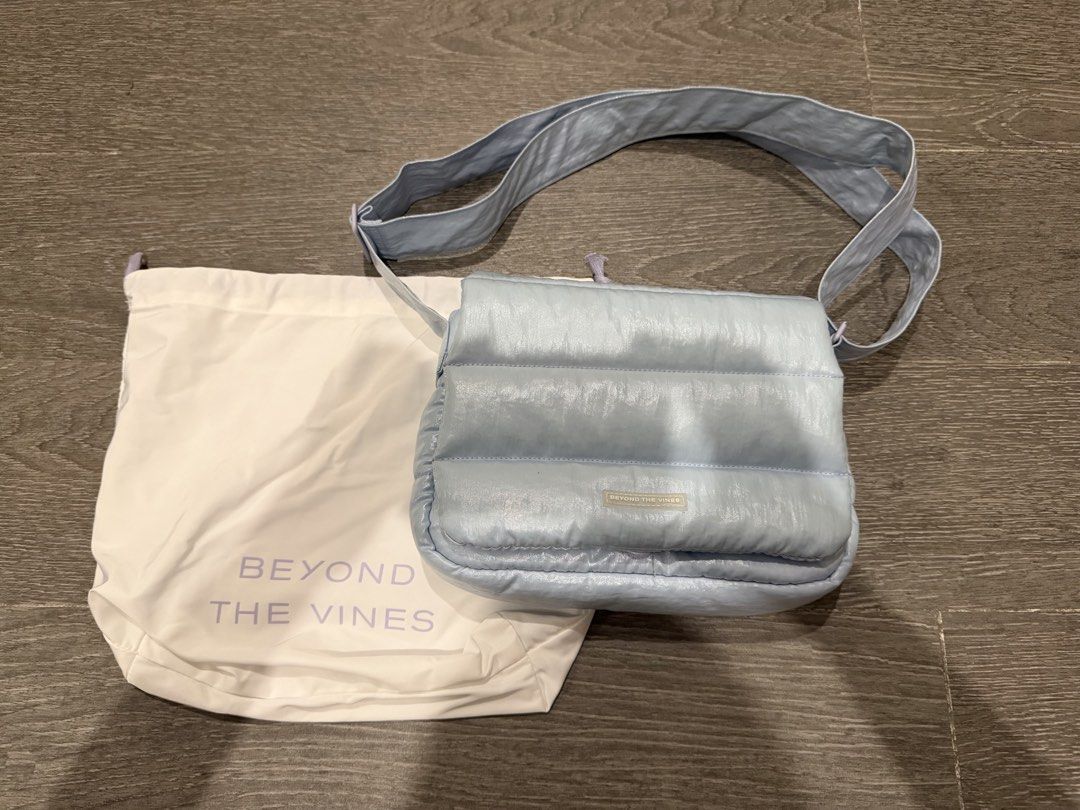 Beyond The Vines Puffer Metallic Bag Light Blue (Category: Cross-body Bags) located in Manila. Submitted by pinkyclothes1267 (Listing ID 1469034635, Image 1). Description: - Brand: Beyond The Vines - Style: Puffer Messenger Bag - Color: Light Blue with bright blue interior lining - Features: Padded flap closure with snap button, interior zippered pocket, interior divider, and adjustable shoulder strap - Inclusions: Comes with original dust bag - 