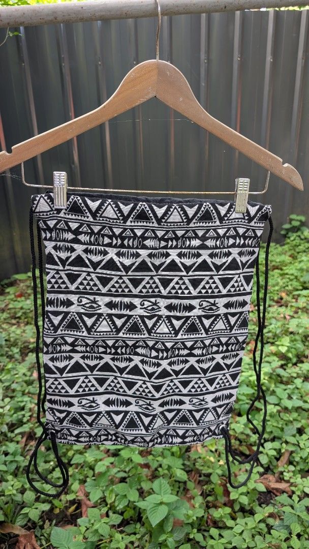 Black and White Aztec Print String Bag Drawstring Backpack (Category: Tote Bags) located in Manila. Submitted by alyssaapac81898 (Listing ID 1469000283, Image 1). Description: - Design: Trendy black & white tribal geometric pattern - Size: Standard daily-use capacity - Material: Durable fabric with sturdy black drawstrings - Storage: Main compartment plus an extra inside zipper pocket for small items - Condition: Brand new and ready to ship - Per