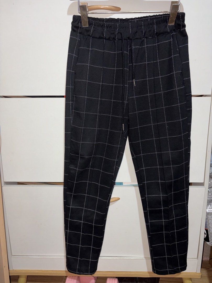 Black and White Checkered Tapered Pants Drawstring Waist (Category: Other Bottoms) located in Siquijor. Submitted by yhostuff (Listing ID 1469042428, Image 1). Description: - Color & Pattern: Black with an all-over white checkered grid - Fit: Modern tapered leg with an elastic waistband and matching black drawstring - Features: Functional front pockets and a neat pressed crease down each leg - Material: Soft, textured fabric for comfortable all-d