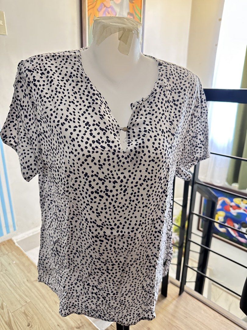 Black and white patterned short sleeve blouse with button (Category: Blouses) located in Manila. Submitted by rachael_23 (Listing ID 1469084538, Image 1). Description: - Style: Casual top with a stylish black and white abstract dot pattern - Fit: Relaxed fit with short sleeves and lightweight, flattering fabric - Neckline: V-neck featuring a cute small front button closure - Versatility: Perfect for everyday wear, errands, or office settings - Co