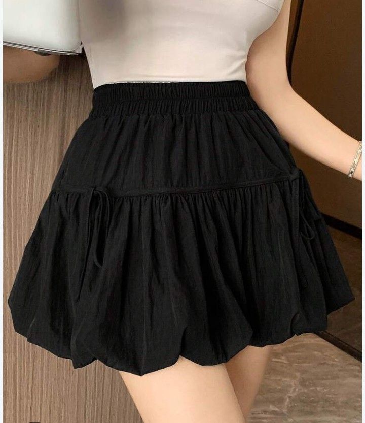 Black bubble skirt tiered ruffled mini skirt (Category: Skirts) located in Marikina City. Submitted by newowners2025 (Listing ID 1468950550, Image 2). Description: Size: Small - Medium Length: 17 in Waist: 24-38 in (garterized) Style: Y2K black bubble mini skirt Fit: Comfortable elastic waistband for an easy fit Fabric: Lightweight with plenty of volume and flare Pairing: Perfect to match with basic crop tops or baby tees With built-in shorts. no