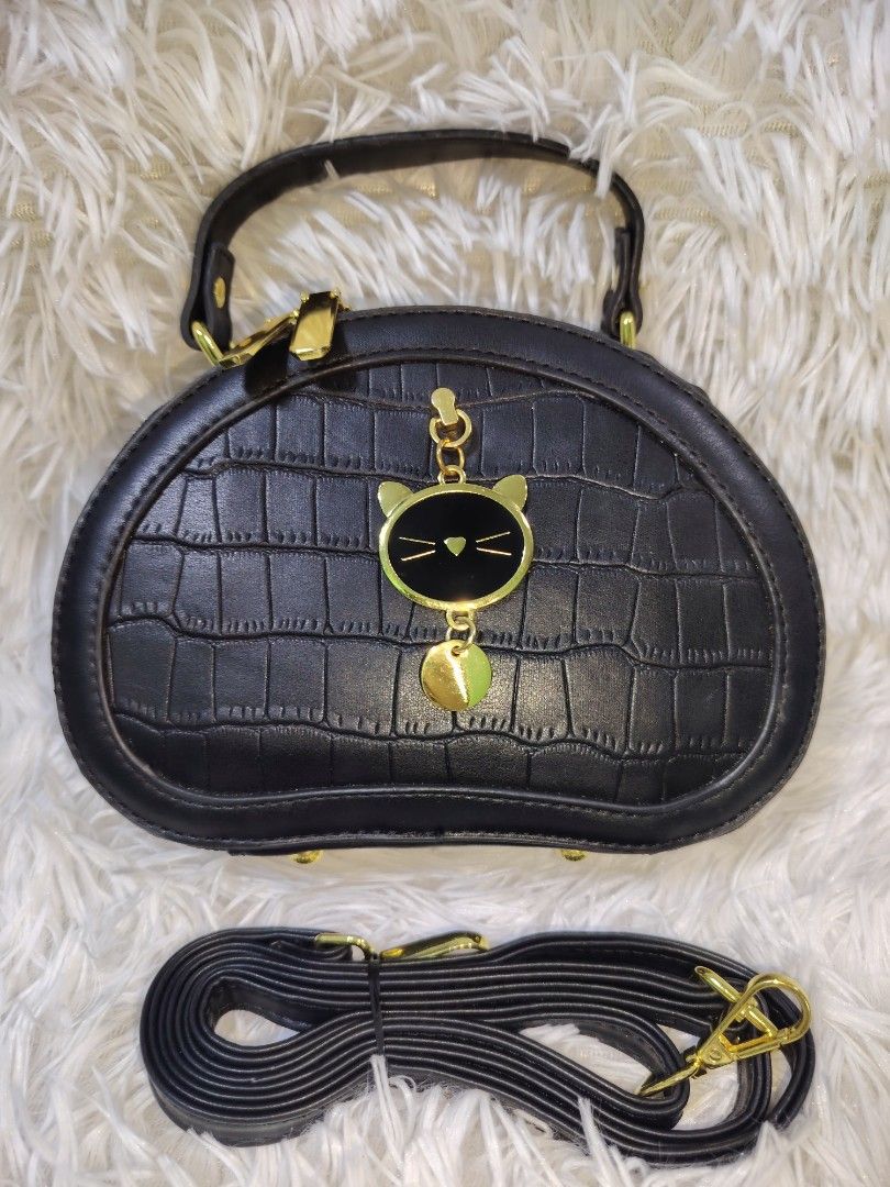 Black Crocodile Texture Cat Charm Handbag with Strap (Category: Cross-body Bags) located in Quezon City. Submitted by zhelcloset01 (Listing ID 1469064575, Image 1). Description: - Color: Black with luxury faux crocodile texture - Hardware: Elegant gold-tone with secure zipper closures - Compartments: Two spacious main zipped compartments - Handles & Strap: Double top handles plus a detachable, long adjustable shoulder strap - Extra Details: Inclu