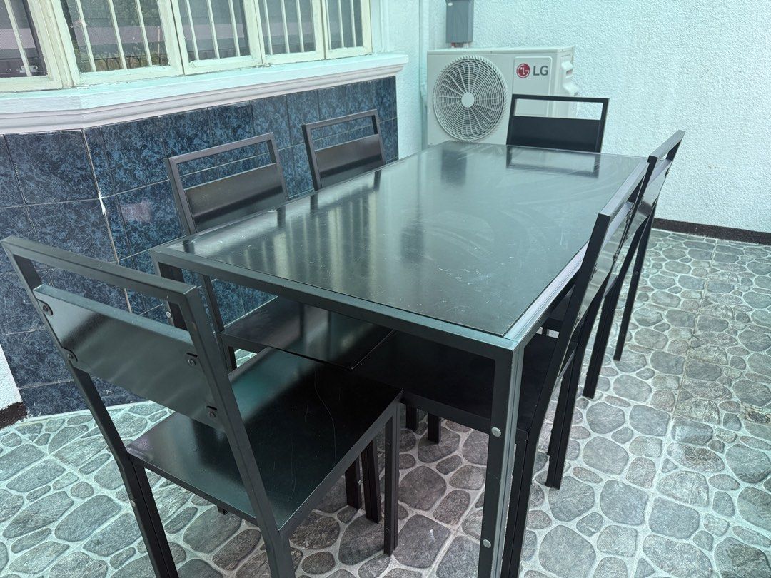 Black Dining Table Set with 6 Chairs (Category: Tables & Sets) located in Pasig City. Submitted by kevinmonte317 (Listing ID 1468991879, Image 2). Description: - Complete set: 1 black dining table and 6 matching chairs - Sturdy metal frame construction for long-lasting durability - Tabletop features a sleek dark glass surface - Chairs designed with low-profile metal backrests and comfortable black seats - Versatile design suitable for both indoor