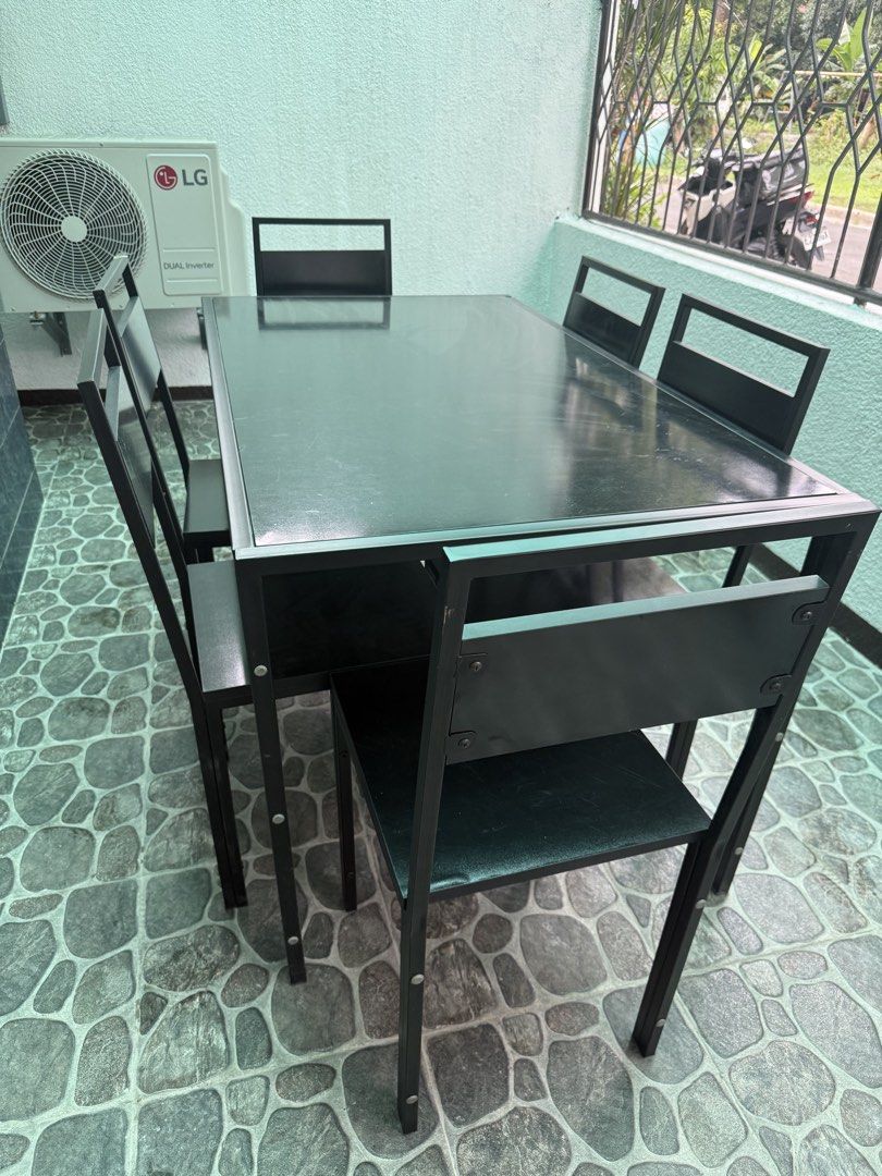 Black Dining Table Set with 6 Chairs (Category: Tables & Sets) located in Pasig City. Submitted by kevinmonte317 (Listing ID 1468991879, Image 3). Description: - Complete set: 1 black dining table and 6 matching chairs - Sturdy metal frame construction for long-lasting durability - Tabletop features a sleek dark glass surface - Chairs designed with low-profile metal backrests and comfortable black seats - Versatile design suitable for both indoor